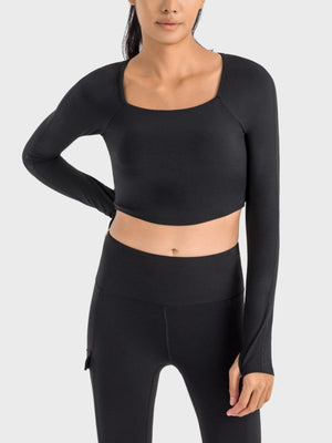 a woman wearing a black crop top and leggings