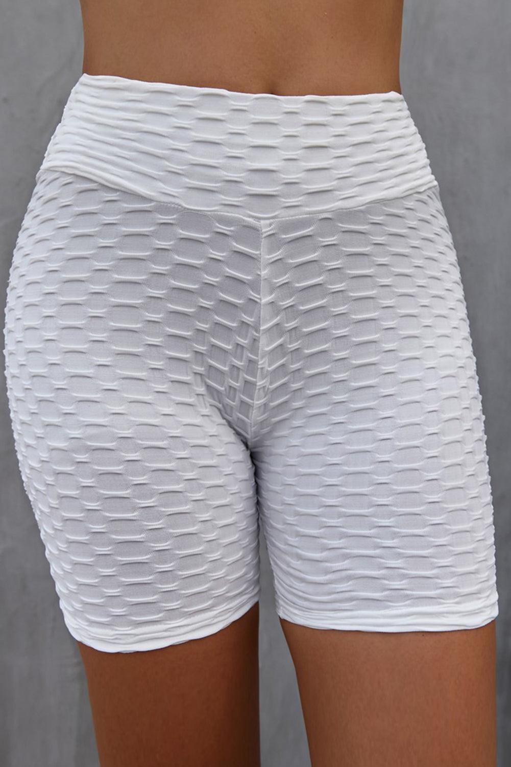 a close up of a person wearing white shorts