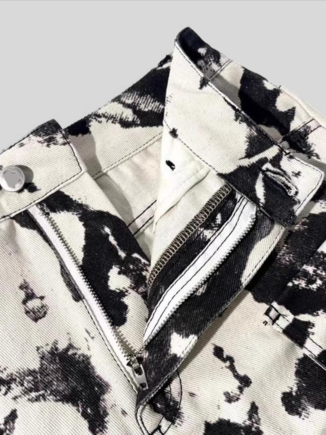 a close up of a black and white tie dye pants