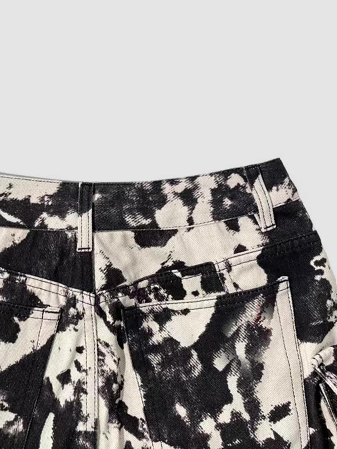 a pair of black and white shorts with a tie dye pattern