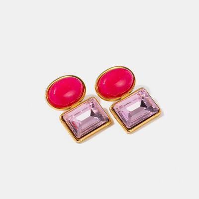 a pair of pink and gold earrings