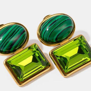 a pair of green and gold cuff links