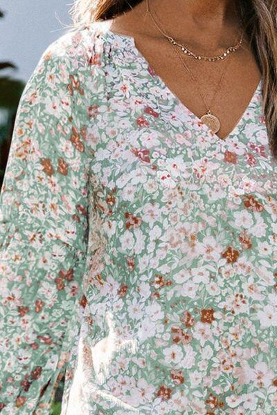 a close up of a woman wearing a floral top