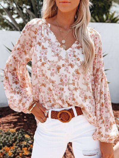 a woman wearing white jeans and a floral blouse