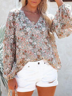 a woman wearing white shorts and a floral top