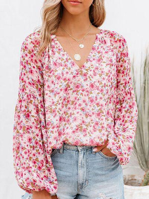 a woman wearing a pink floral top