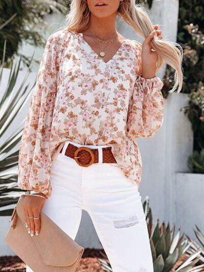 a woman wearing white jeans and a floral blouse