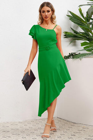 a woman wearing a green dress and heels