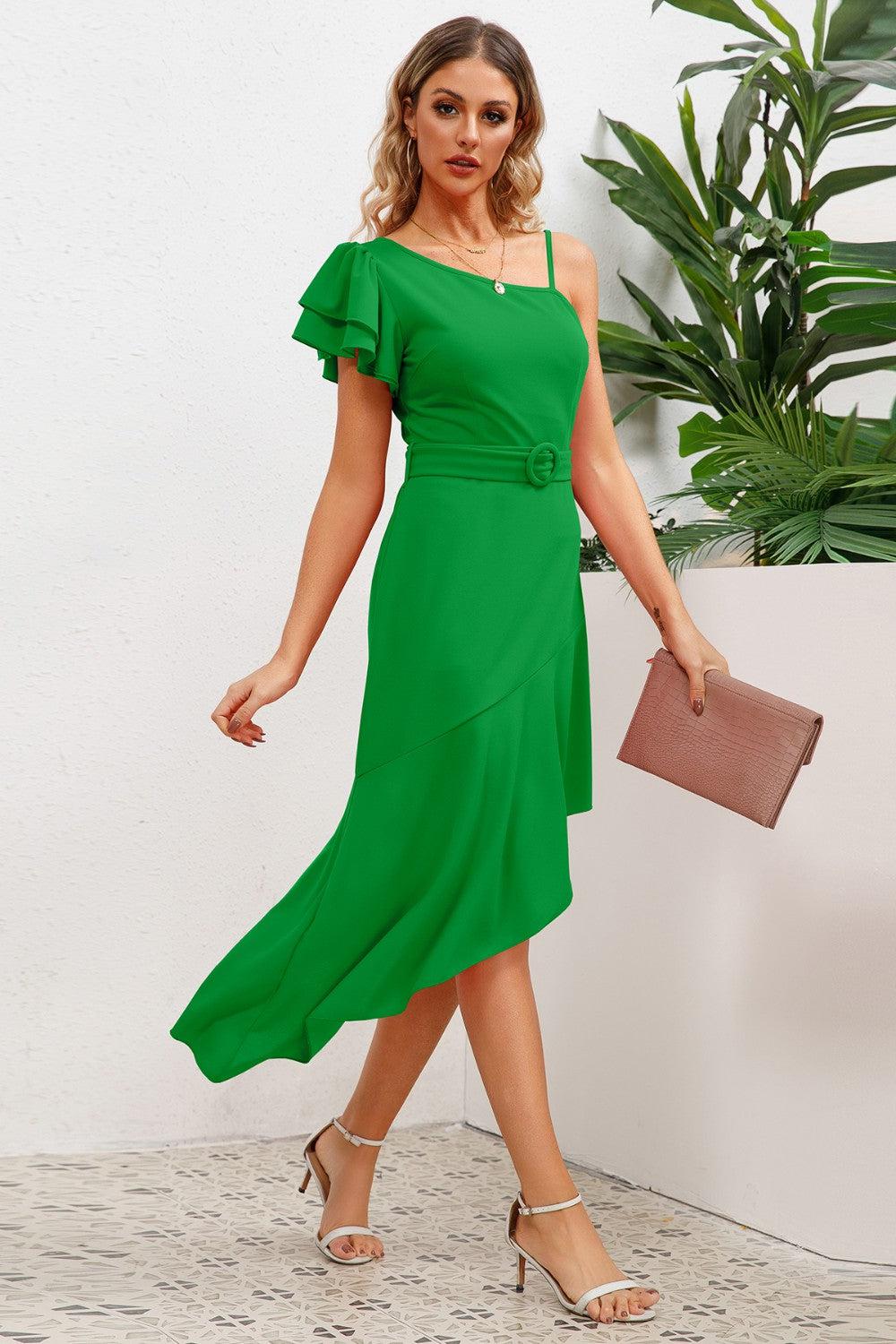 a woman wearing a green dress and heels