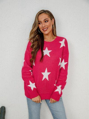 a woman wearing a pink sweater with white stars on it
