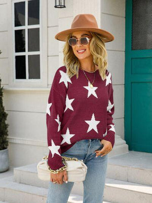a woman wearing a star sweater and jeans