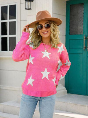 a woman wearing a pink sweater and a brown hat