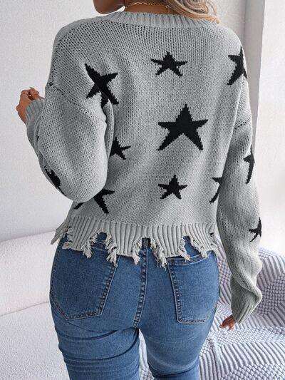 a woman wearing a sweater with stars on it