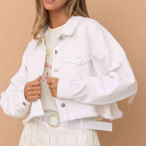 a woman wearing a white jacket and skirt