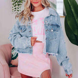 a woman wearing a denim jacket and pink skirt
