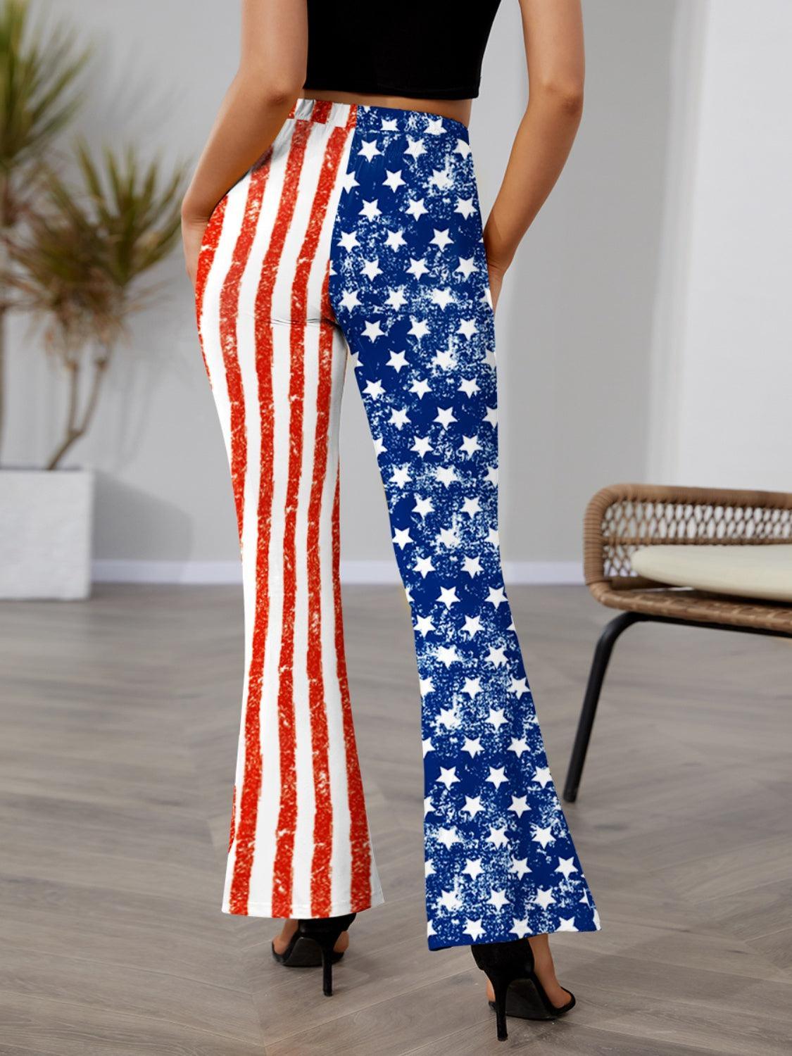 a woman in a black top and red, white, and blue american flag pants