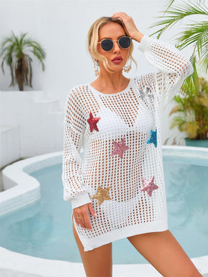 a woman in a white crochet cover up standing next to a pool