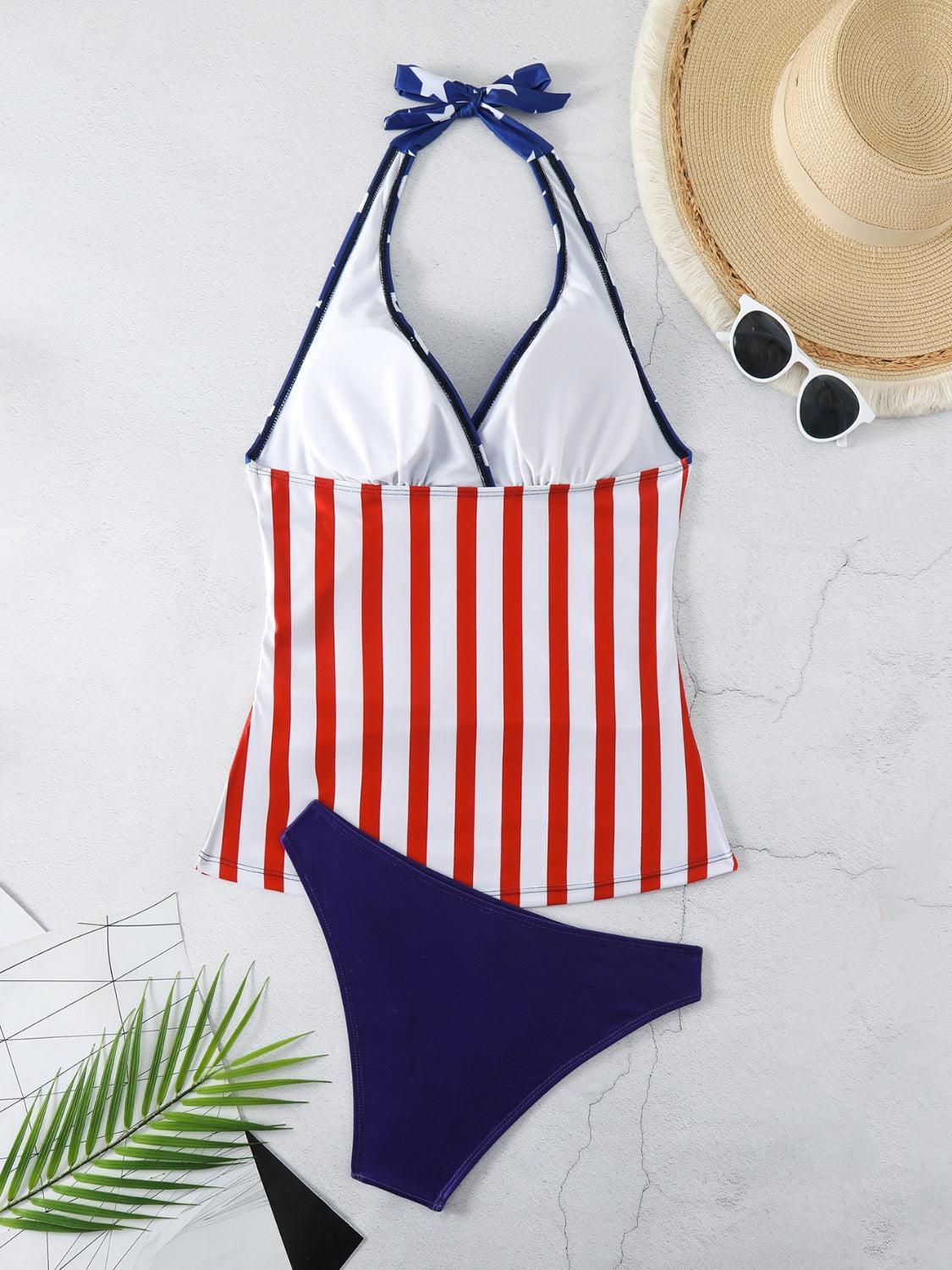a red, white and blue striped swimsuit next to a straw hat