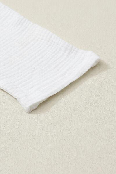 a close up of a white cloth on a white surface