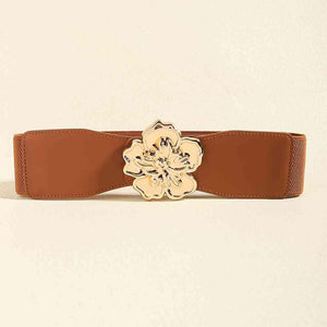 a brown belt with a gold flower buckle