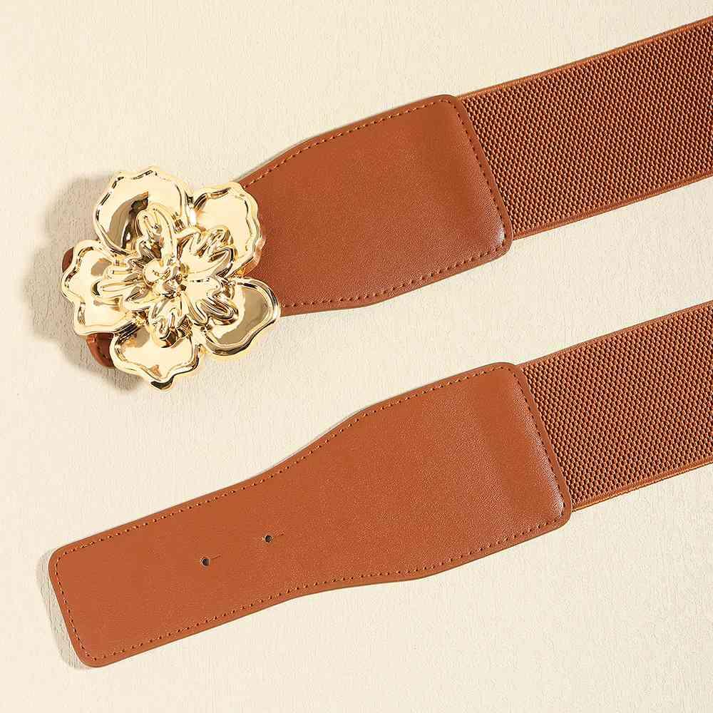 a pair of brown belts with a flower buckle