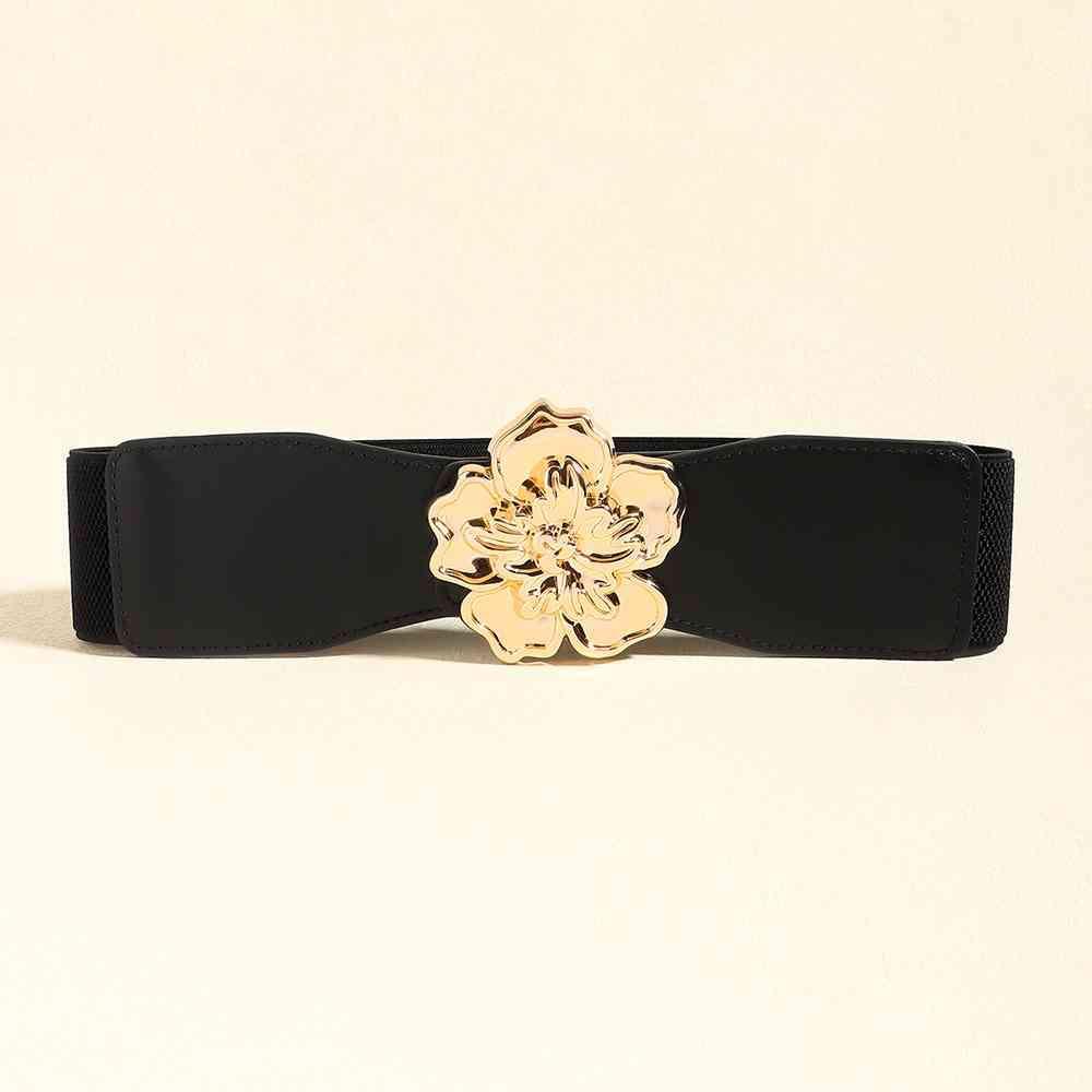 a black belt with a gold flower buckle