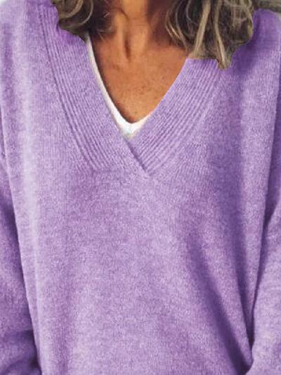 a woman wearing a purple sweater and hat