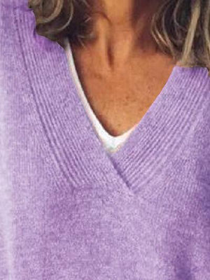 a close up of a person wearing a purple sweater