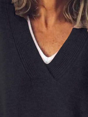 a close up of a person wearing a black sweater