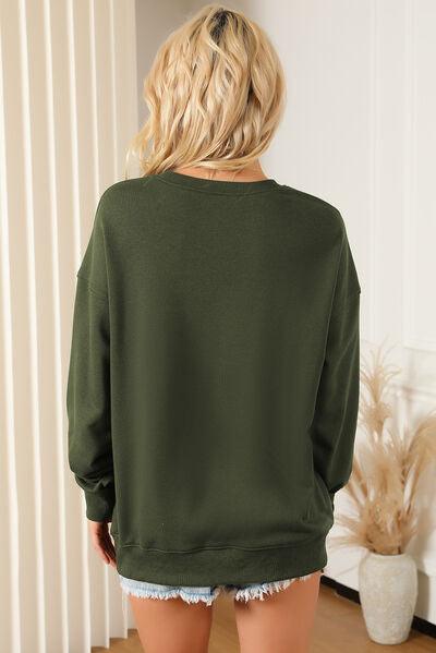 a woman wearing a green sweatshirt and ripped shorts