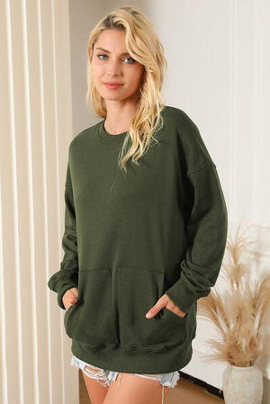 a woman in a green sweatshirt posing for a picture