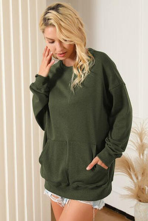 a woman in a green hoodie posing for a picture
