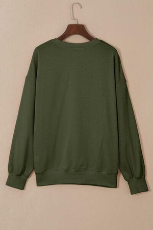 a green sweatshirt hanging on a hanger