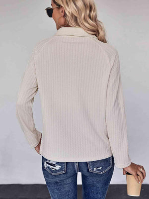 a woman wearing a white sweater and jeans