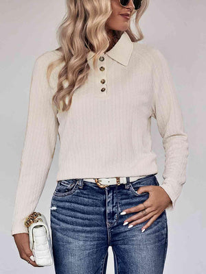 a woman wearing a white sweater and jeans