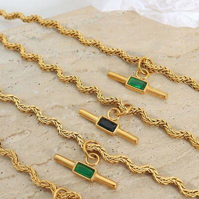 a group of gold chains with green and black stones