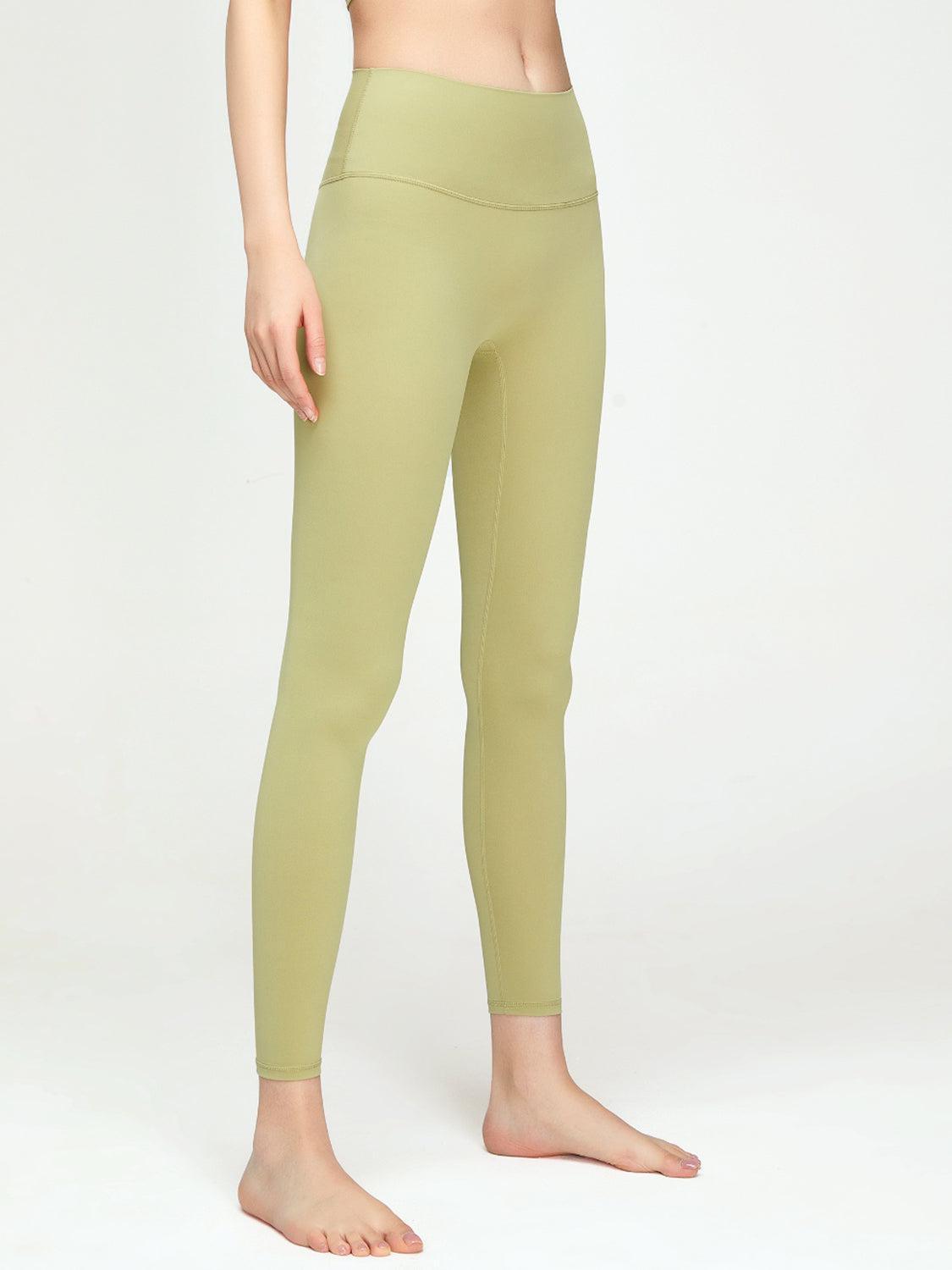 a woman in a green top and leggings