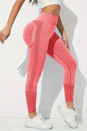 a woman in a white top and pink leggings