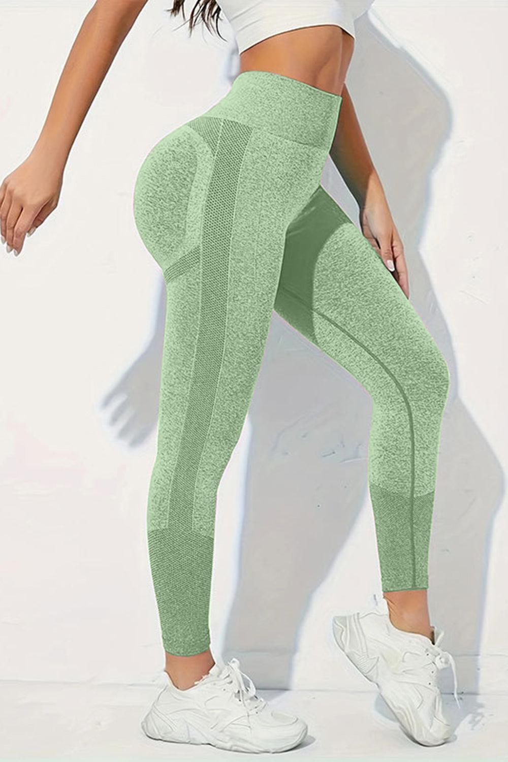 a woman in a white top and green leggings