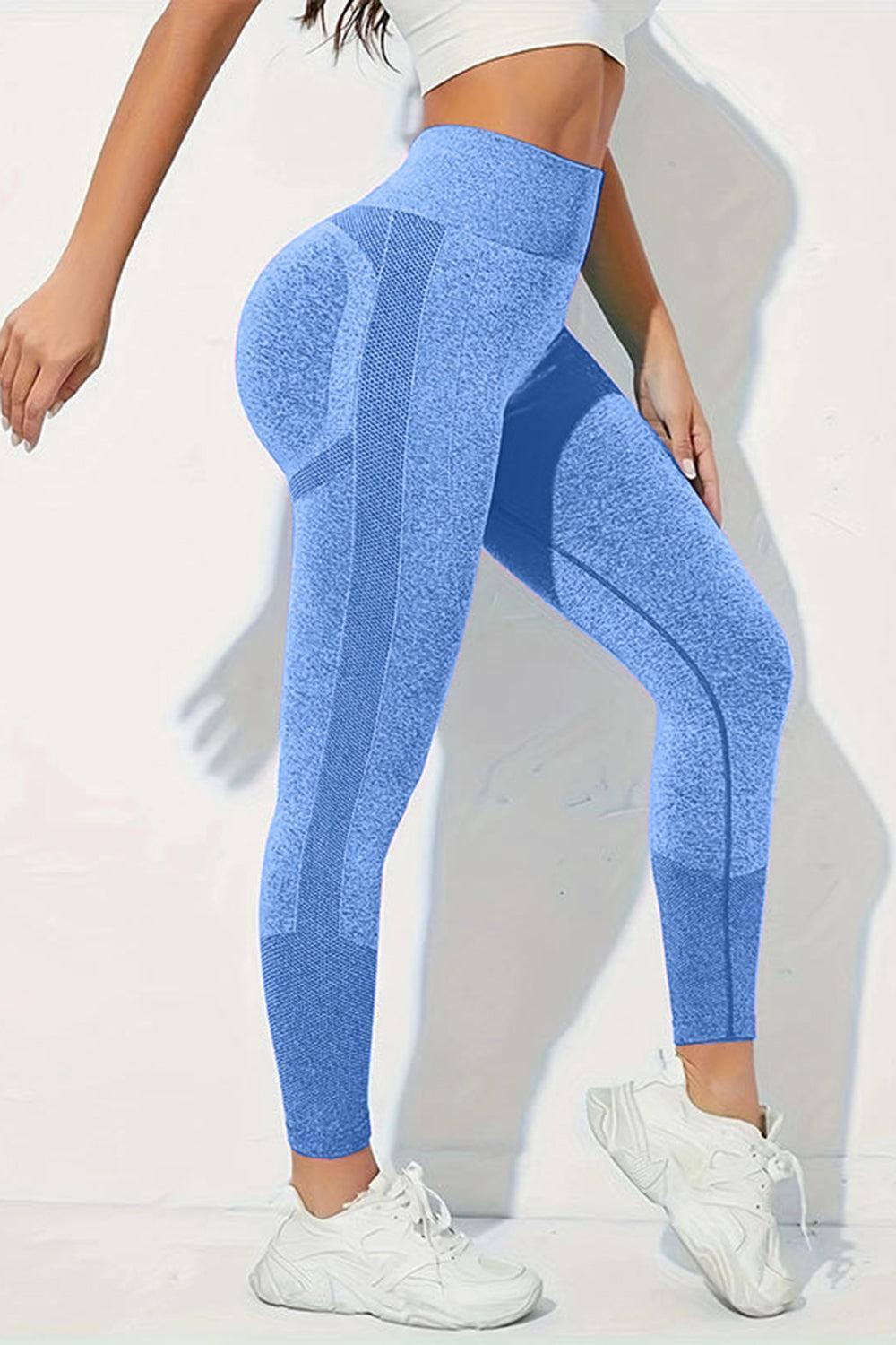 a woman in a white top and blue leggings