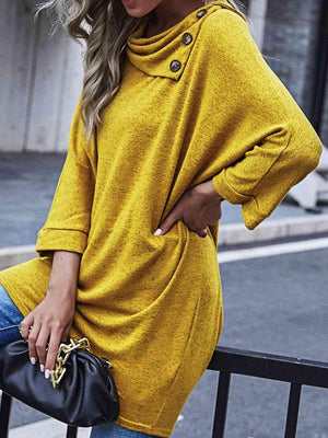 a woman wearing a yellow sweater and jeans