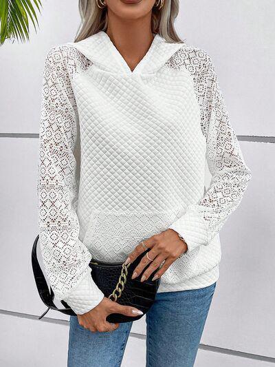 a woman wearing a white sweater and jeans