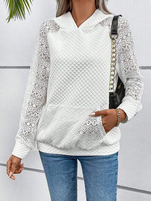 a woman wearing a white sweater and jeans