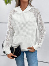 a woman wearing a white sweater and jeans