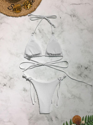 a white bikinisuit with a hat on top of it
