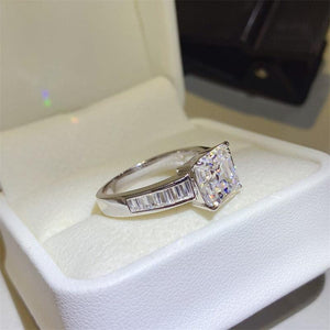 a diamond ring sitting on top of a white box