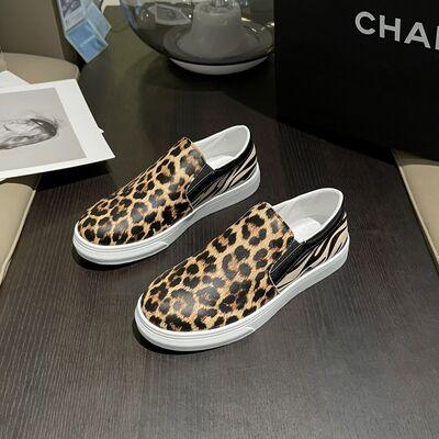 a pair of leopard print slip on sneakers