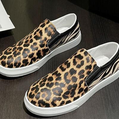 a pair of leopard print slip on shoes