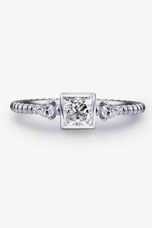 a white gold ring with a princess cut diamond