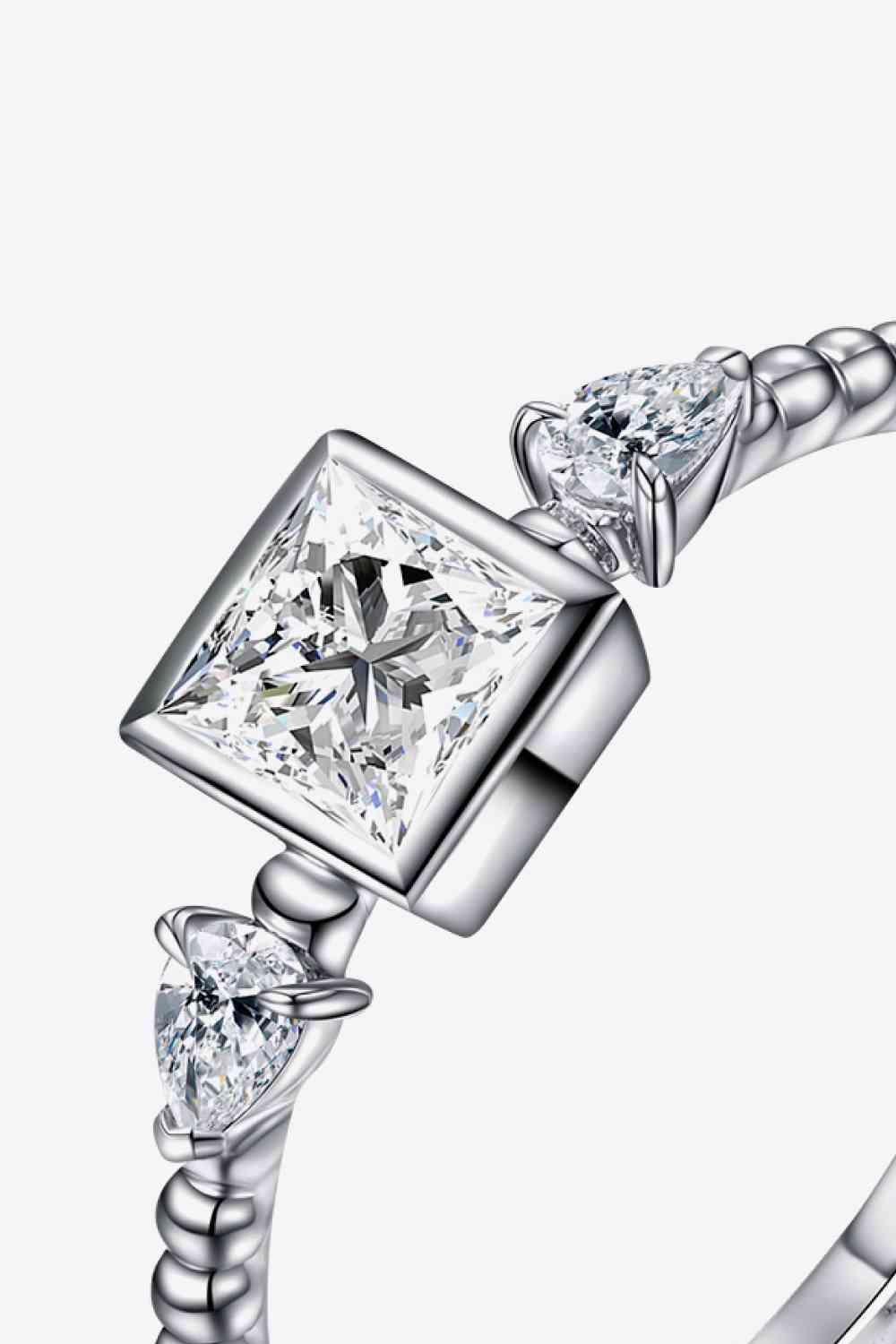 a white gold ring with a princess cut diamond